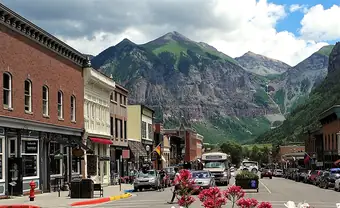 Colorado Avenue in Telluride, with the peaks of the box canyon behind it