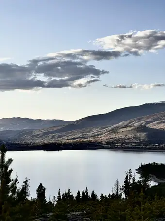 Dillon Reservoir at dusk, still water below the mountains of Summit County