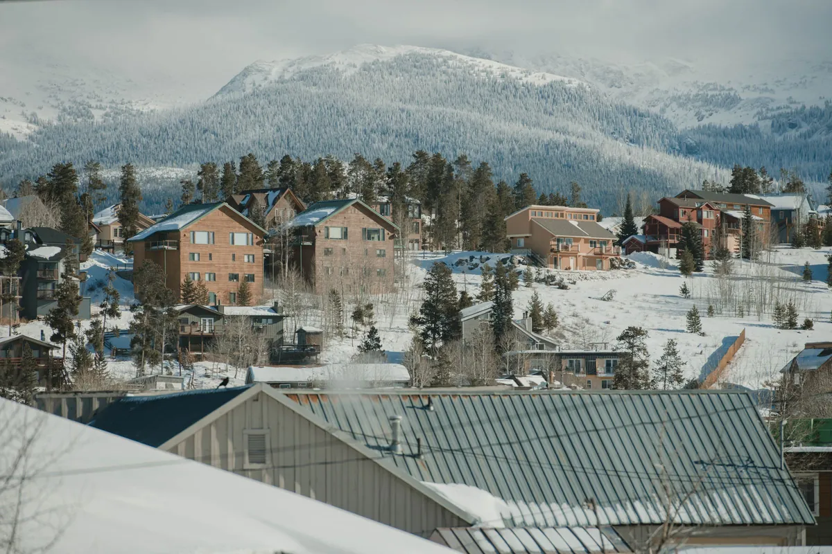 Snow-covered rooftops in Breckenridge with the Ten Mile Range behind