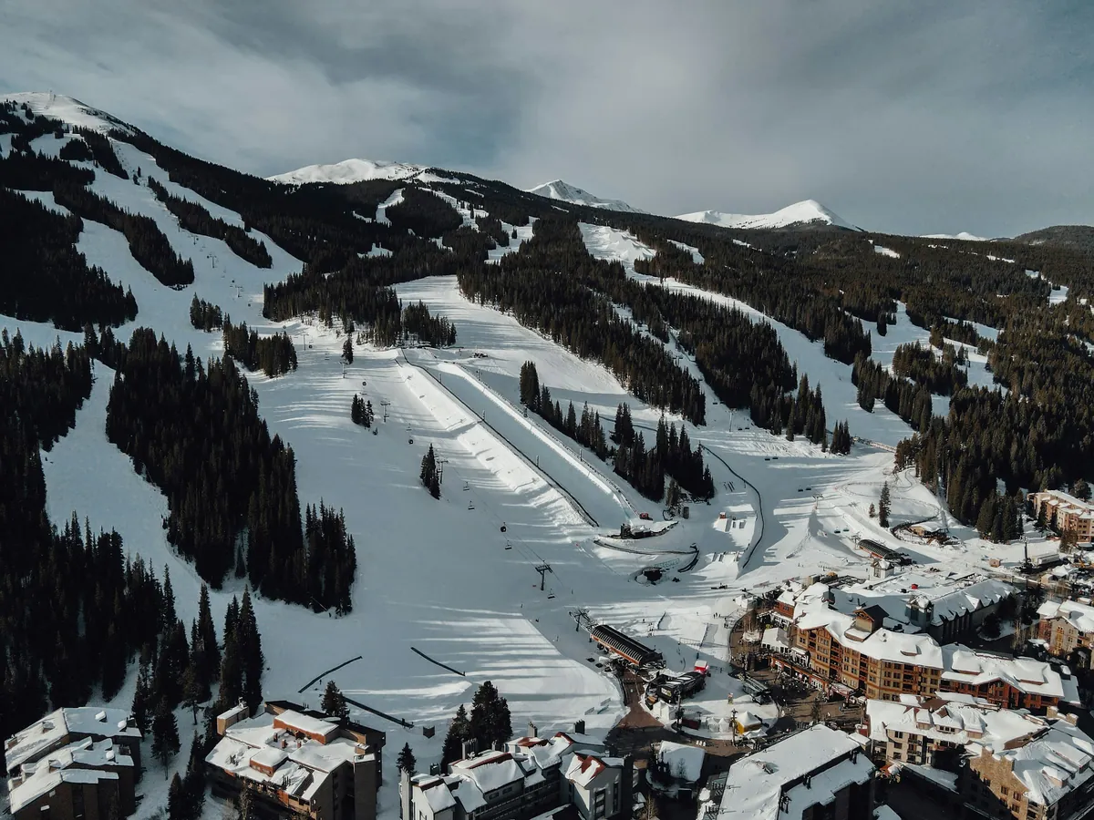 Copper Mountain from the air: groomed runs and the base village in snow