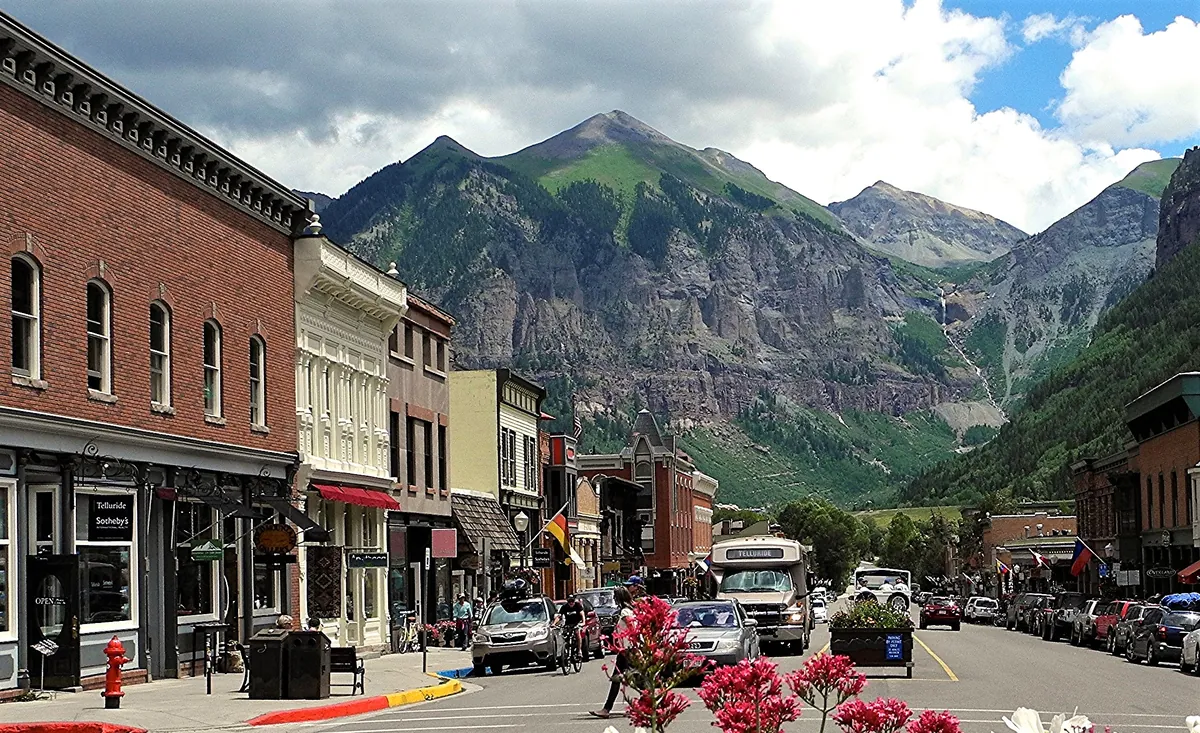Colorado Avenue in Telluride, with the peaks of the box canyon behind it