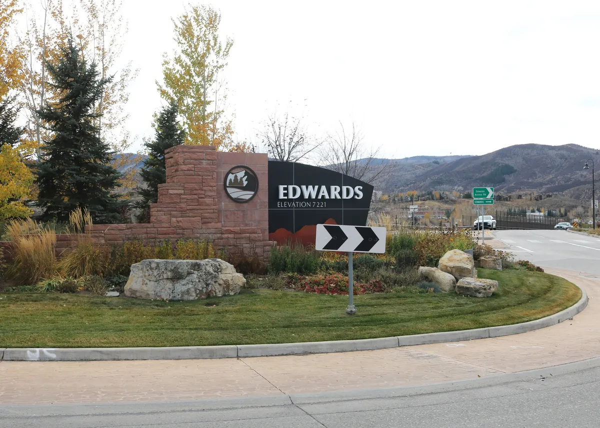 The Edwards town sign, elevation 7,221, at a roundabout with the Vail Valley hills behind